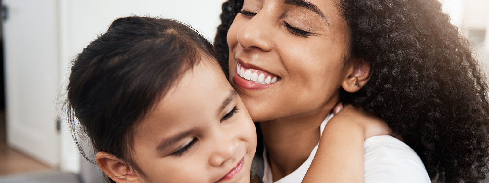 A mother and daughter embracing.